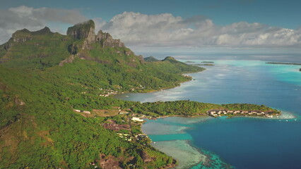 Capturing breathtaking drone footage of Bora Bora, featuring iconic mount Otemanu, luxurious overwater bungalows, and vibrant coral reefs in a tropical paradise. Travel tropical vacation concept