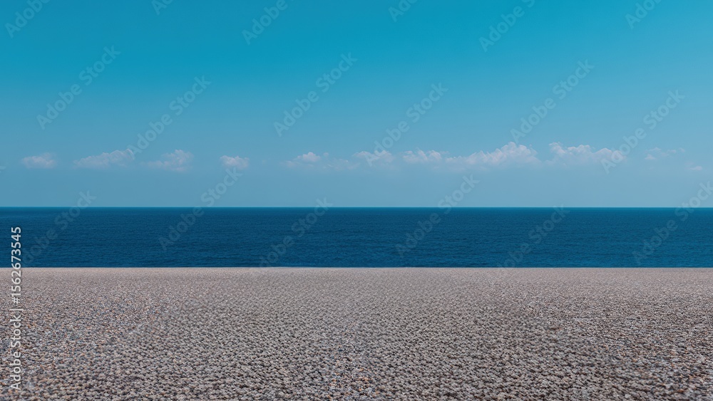 Poster endless expanse of deep blue sea meeting a vast pebble beach under a serene sky dotted with small wh