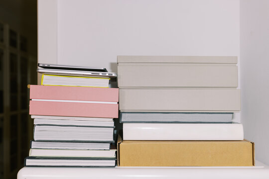 Stack of Neatly Organized Books and laptops