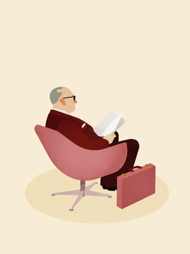 Senior businessman reading document sitting on chair with briefcase