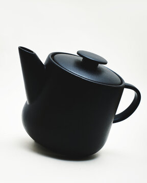 black ceramic teapot on white