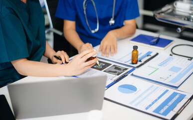 Medicine doctor hand working with modern computer and smart phone,digital tablet with his team on...