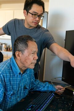 son helping dad computer 