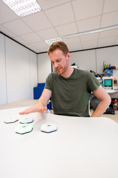 Engineer testing new interactive luminous device in modern office