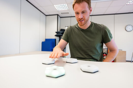Doctor using innovative rehabilitation equipment with led lights