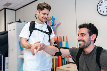 Physiotherapist assisting patient doing arm exercises