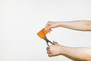 Person cutting payment credit business card with silver scissors 