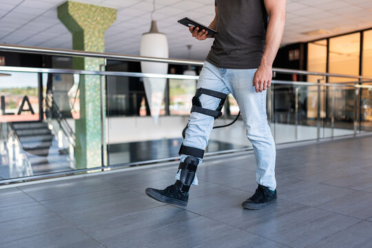 Engineer walking with exoskeleton and holding tablet
