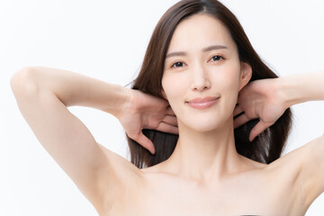 白バックでスキンケアをする若い女性