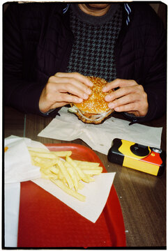 disposable camera and man eating a burger, 35mm