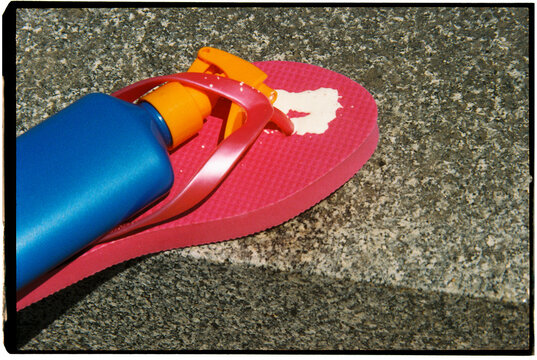 sunblock on a pink flip-flop, 35mm
