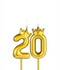 Golden number 20 birthday candle on white background