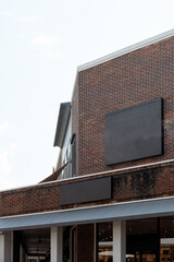 Urban building facade with red brick wall, blue canopy under bright sunlight. Modern classic exterior architecture in city area.
