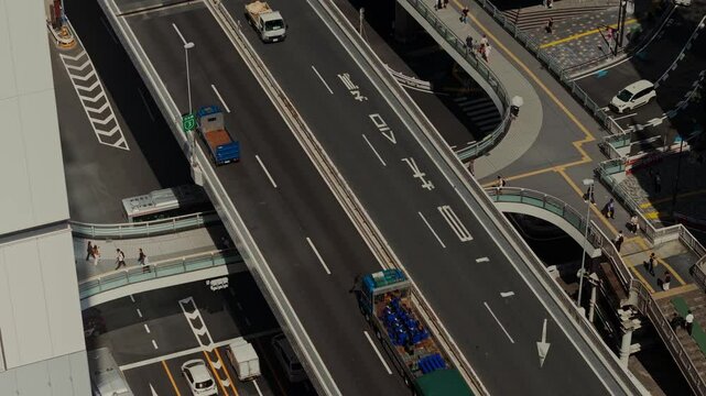 Bird's-eye view of a busy road junction with pedestrian crossings. Tokyo, Japan from a drone