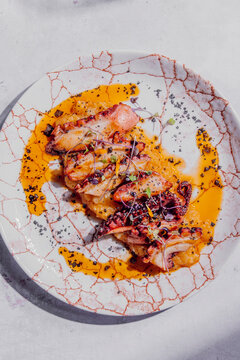 Octopus with creamy mashed potatoes, paprika oil and black salt