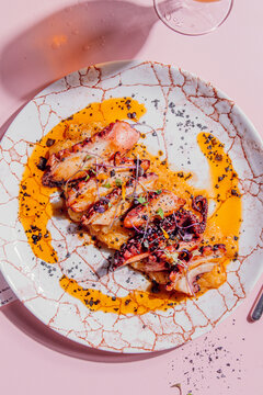 Octopus with creamy mashed potatoes, paprika oil and black salt