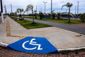 Accessible sidewalk with ramp and signage for people with disabilities (PWD). Illustrates inclusion...