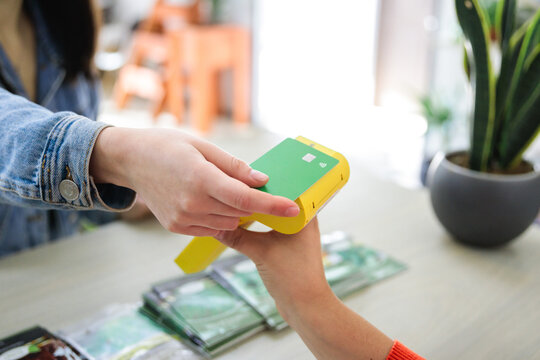 Unrecognizable customer paying with contactless credit card