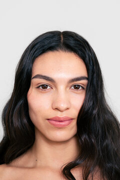 Front-Facing Portrait of Woman with Natural Makeup and Wavy Hair