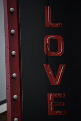 Neon red sign saying love, a sign saying love
