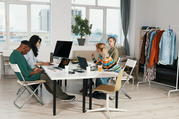 young adult colleagues working together in modern workplace, business meeting, socializing friends...