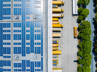 Aerial View of Factory with Solar Panels and Transport Trucks