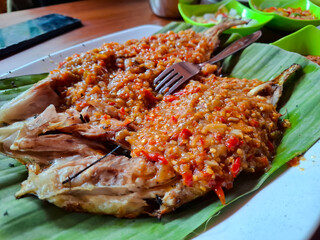 Grilled Fish Topped with Spicy Chili Sauce on a Leaf Platter