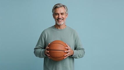 Smiling Mature Man Holding Basketball, Studio Shot