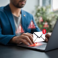 Person typing on laptop with email notification and warning signs