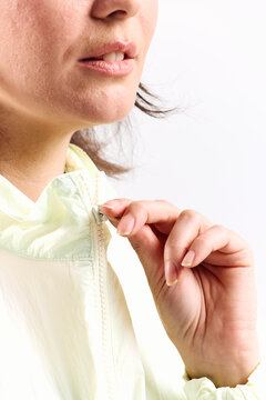 Sportswoman zips up her jacket