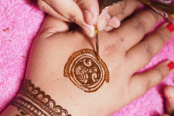 Henna design applied to hand at celebration