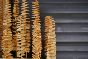 Unique wooden spiral sculptures displayed at outdoor market