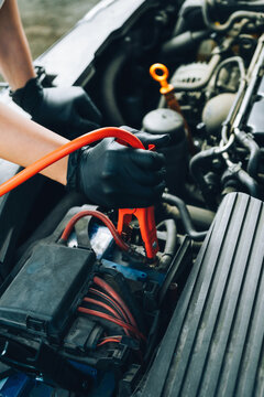 Mechanic connecting jumper cables.