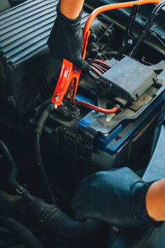 Mechanic connecting jumper cables.