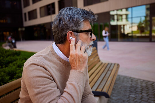 Profile of a man putting on his earphone