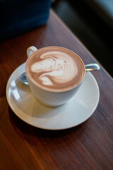 Chocolate latte with intricate milk froth art on top