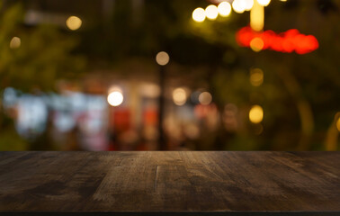 Empty wood table top and blur of restaurant background selective focus product display