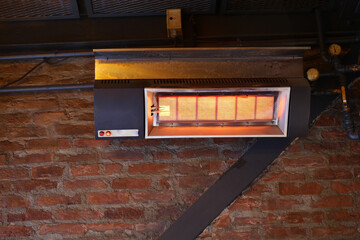 Heating unit on a brick wall in a cozy indoor space