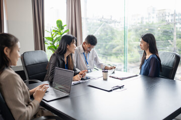 Examiner reading a resume during job interview at office Business and human resources concept.
