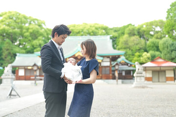 In June 2025, a Japanese couple in their early twenties stands in front of the shrine in Aichi,...
