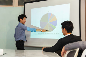 Motivated professional team members gathered together at corporate seminar raise hand, agree with...