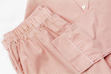 Top view of folded red striped pajama, close up textured details. Minimal style banner, comfort...