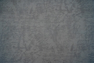 Abstract textured surface in muted gray tones.