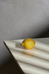 A cozy backdrop with fresh fruits and grass on a table with natural sunlight and shadows.