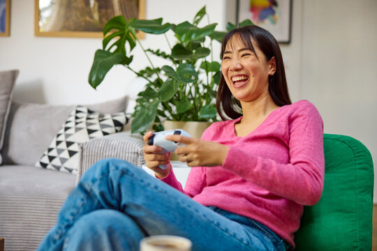 Excited woman plays video games