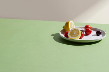 A cozy backdrop with fresh fruits and grass on a table with natural sunlight and shadows.