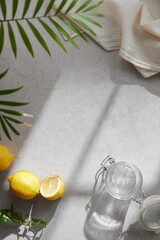 A cozy backdrop with fresh fruits and grass on a table with natural sunlight and shadows.
