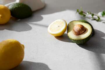 A cozy backdrop with fresh fruits and grass on a table with natural sunlight and shadows.