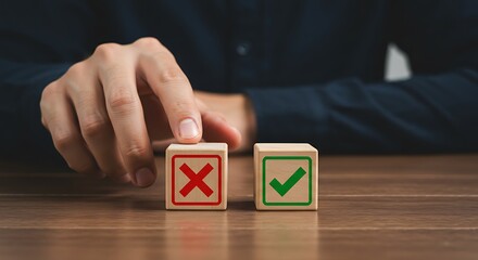 Hand choosing between right and wrong on wooden blocks on a table
