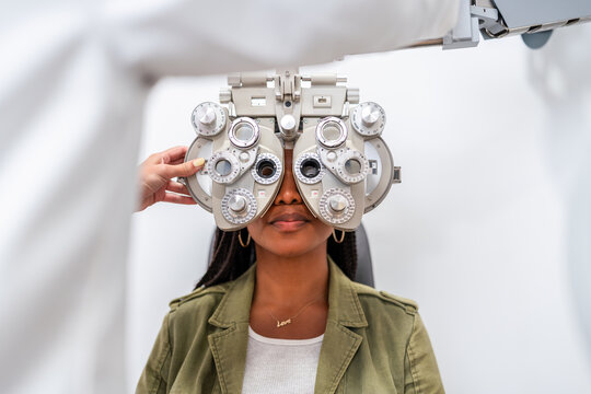 Optician Conducting Eye Exam with Phoropter